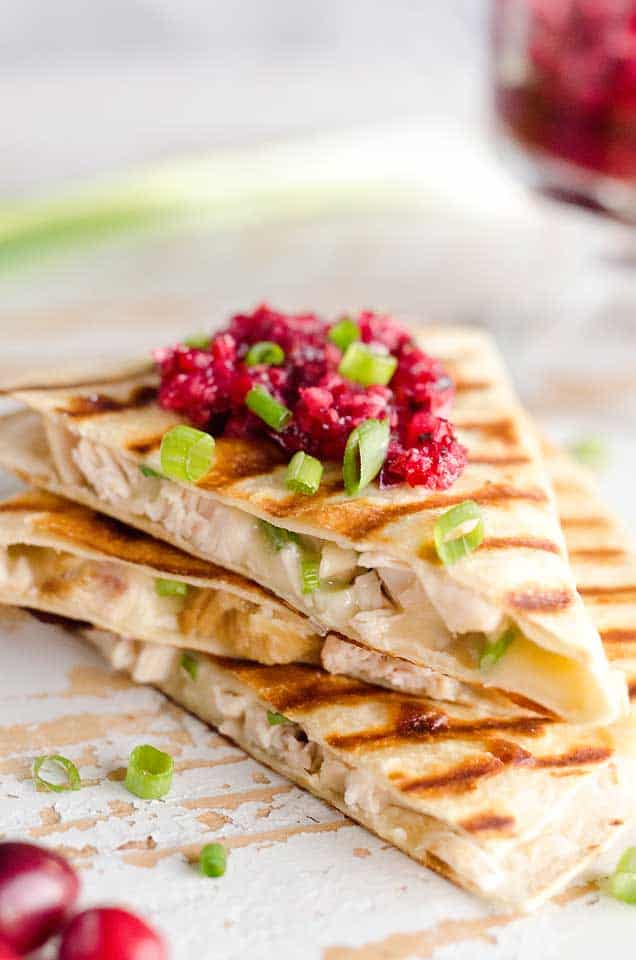 Light Cranberry Turkey Quesadilla are a healthy and easy meal perfect for using up all of that leftover turkey from Thanksgiving! Fill a light tortilla with turkey, havarti cheese and green onions and top it with cranberry salsa for a delicious and unique dinner after the holidays!