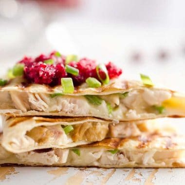 Light Cranberry Turkey Quesadilla are a healthy and easy meal perfect for using up all of that leftover turkey from Thanksgiving! Fill a light tortilla with turkey, havarti cheese and green onions and top it with cranberry salsa for a delicious and unique dinner after the holidays!