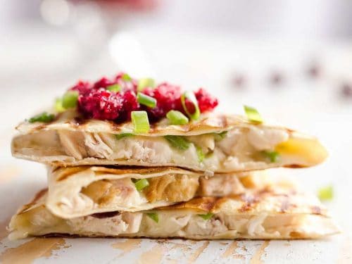 Light Cranberry Turkey Quesadilla are a healthy and easy meal perfect for using up all of that leftover turkey from Thanksgiving! Fill a light tortilla with turkey, havarti cheese and green onions and top it with cranberry salsa for a delicious and unique dinner after the holidays!