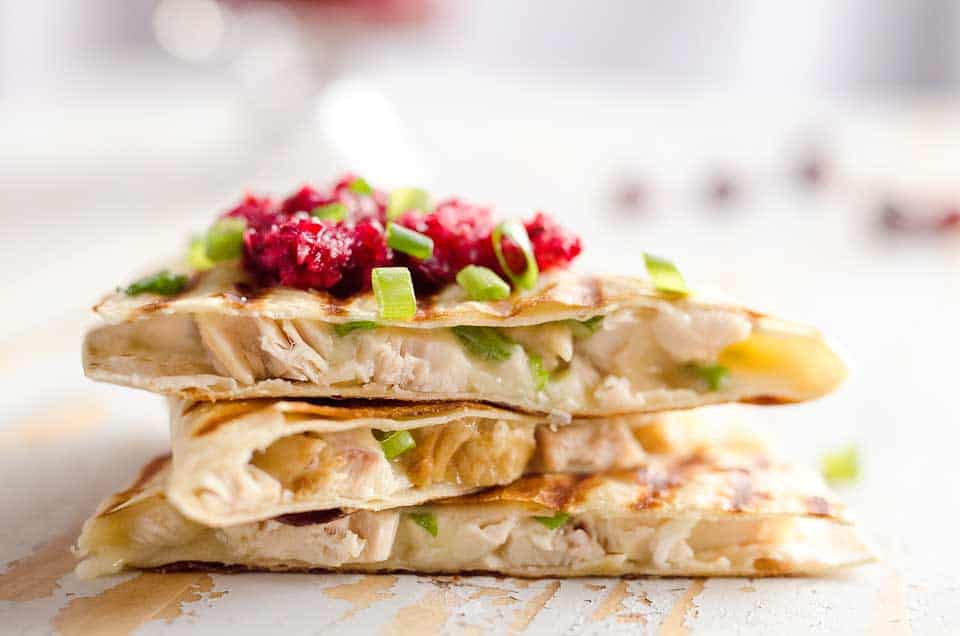 Light Cranberry Turkey Quesadilla are a healthy and easy meal perfect for using up all of that leftover turkey from Thanksgiving! Fill a light tortilla with turkey, havarti cheese and green onions and top it with cranberry salsa for a delicious and unique dinner after the holidays!