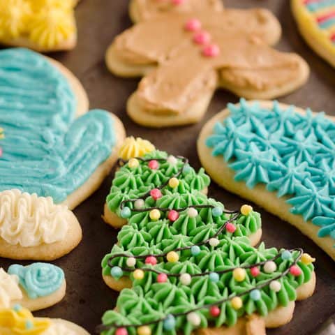 cut out sugar cookies frosted on baking pan