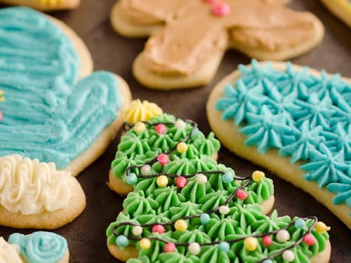 cut out sugar cookies frosted on baking pan
