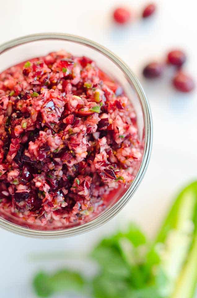 Spicy Cranberry Salsa is a fresh blend of cranberries, jalapeños, cilantro, honey and citrus for a healthy condiment perfect with turkey or spread on cream cheese and served with crackers for an easy appetizer!