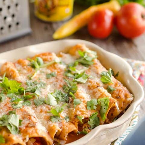 30 Minute Light Chicken Enchiladas are full of crumbled chicken & vegetables and a spicy enchilada sauce for an easy weeknight dinner!