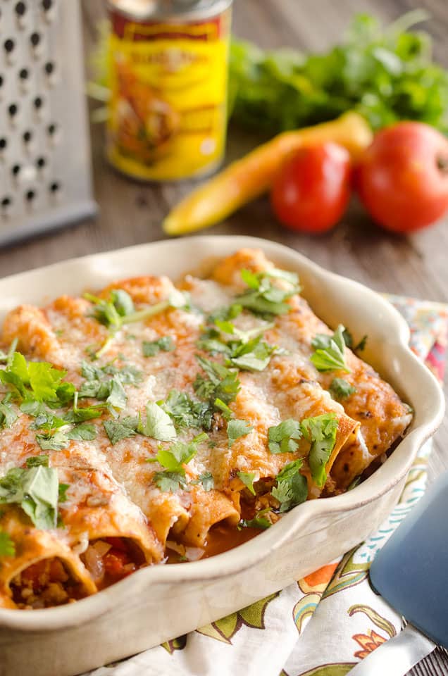 30 Minute Light Chicken Enchiladas are full of crumbled chicken & vegetables and a spicy enchilada sauce for an easy weeknight dinner!