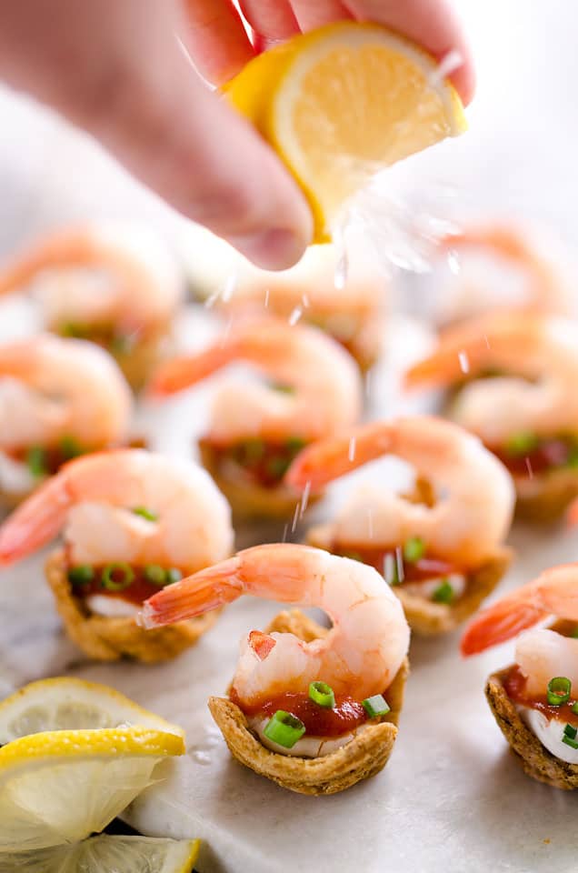 Light Shrimp Cocktail Bites are the perfect finger food to celebrate a holiday party. These individual bites of shrimp cocktail are lightened up with reduced fat cream cheese and Greek yogurt for a delicious and guilt free finger food you can enjoy!