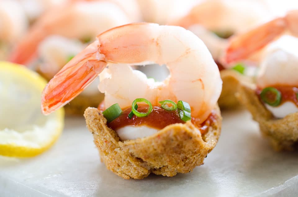 Light Shrimp Cocktail Bites are the perfect finger food to celebrate a holiday party. These individual bites of shrimp cocktail are lightened up with reduced fat cream cheese and Greek yogurt for a delicious and guilt free finger food you can enjoy!