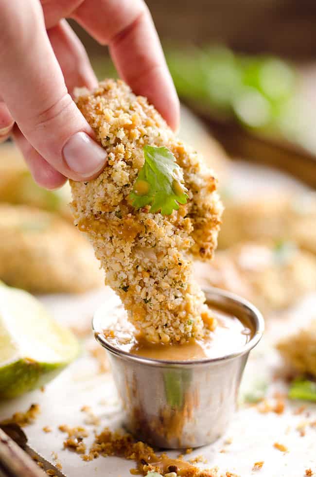 Light Thai Peanut Chicken Tenders are a healthy dinner idea bursting with bold and spicy Thai peanut flavors, paired with a simple two-ingredient sauce with creamy coconut milk!