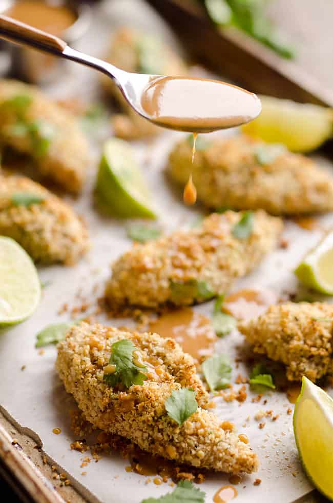 Light Thai Peanut Chicken Tenders are a healthy dinner idea bursting with bold and spicy Thai peanut flavors, paired with a simple two-ingredient sauce with creamy coconut milk!
