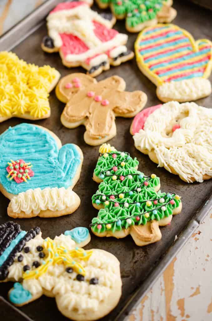 buttercream frosted old fashioned cut out cookies on pan