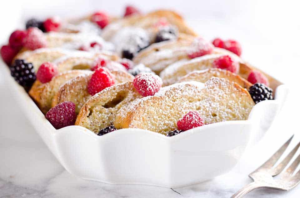 Overnight Berry French Toast Bake is a scrumptious dish so easy to make with a few simple ingredients, including your favorite coffee creamer, International Delight! Throw it together the night before and toss it in the refrigerator so it is ready to bake for your holiday breakfast or brunch!