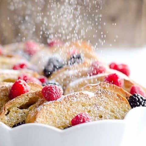 Overnight Berry French Toast Bake is a scrumptious dish so easy to make with a few simple ingredients, including your favorite coffee creamer, International Delight! Throw it together the night before and toss it in the refrigerator so it is ready to bake for your holiday breakfast or brunch!