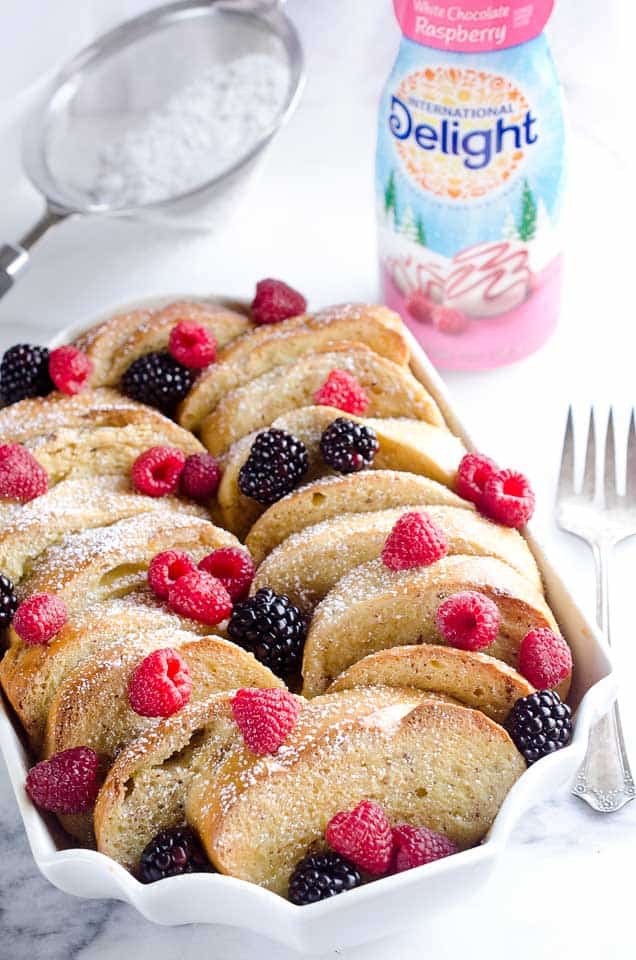 Overnight Berry French Toast Bake is a scrumptious dish so easy to make with a few simple ingredients, including your favorite coffee creamer, International Delight! Throw it together the night before and toss it in the refrigerator so it is ready to bake for your holiday breakfast or brunch!