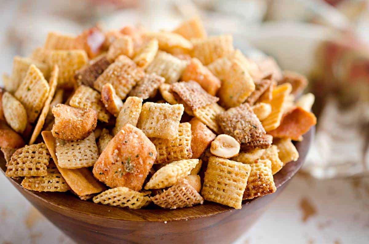 Zesty 3 Cheese Snack Mix is the perfect treat for the holidays with Chex Mix, nuts, cheesy crackers and pretzels coated in ranch seasoning, Parmesan and butter!