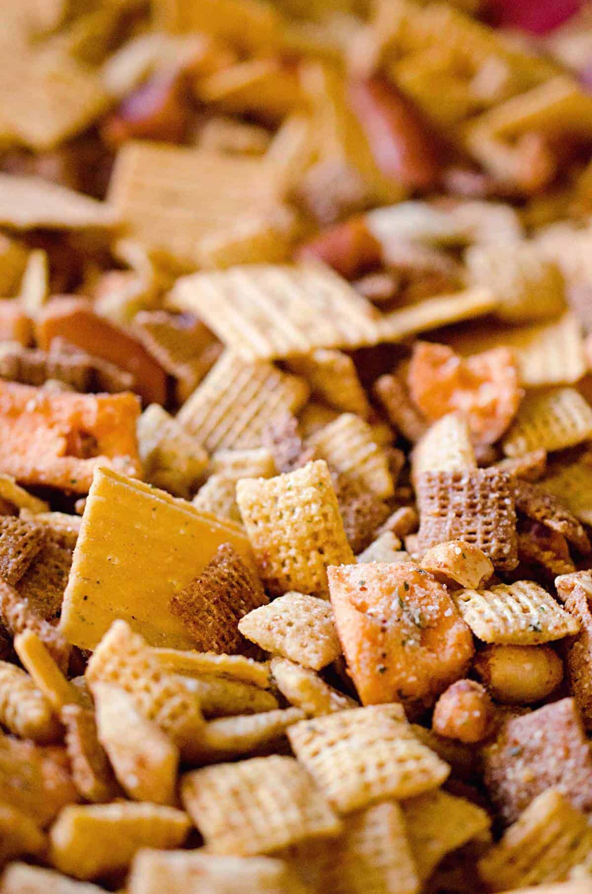 Zesty 3 Cheese Snack Mix is the perfect treat for the holidays with Chex Mix, nuts, cheesy crackers and pretzels coated in ranch seasoning, Parmesan and butter!