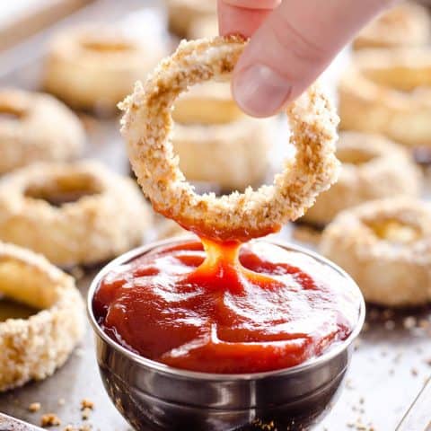 Baked Southwest Onion Rings are a lightened up version of a classic appetizer! Onions are coated in whole wheat flour, eggs, panko break crumbs and a mix of southwest spices and baked instead of fried for a healthy side dish.