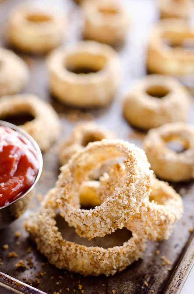 Baked Southwest Onion Rings are a lightened up version of a classic appetizer! Onions are coated in whole wheat flour, eggs, panko break crumbs and a mix of southwest spices and baked instead of fried for a healthy side dish. 