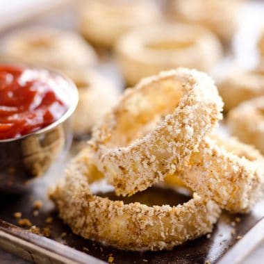 Baked Southwest Onion Rings are a lightened up version of a classic appetizer! Onions are coated in whole wheat flour, eggs, panko break crumbs and a mix of southwest spices and baked instead of fried for a healthy side dish.