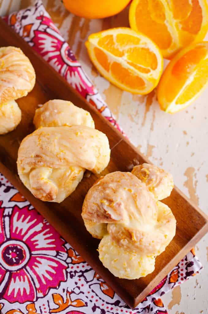 orange sweet roll knots on board with napkin