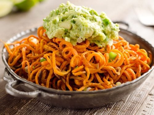 Spicy Roasted Sweet Potato Spirals with Guacamole is an amazingly delicious meatless dinner or appetizer with crispy sweet potatoes coated in garlic & chili powder and topped with a zesty guacamole.