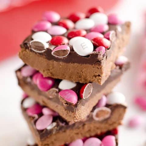 Triple Chocolate Peanut Butter No Bake Bars are a delicious dessert recipe ready in only 15 minutes. This sweet treat is perfect for Valentine's day or any time a peanut butter and chocolate craving strikes!