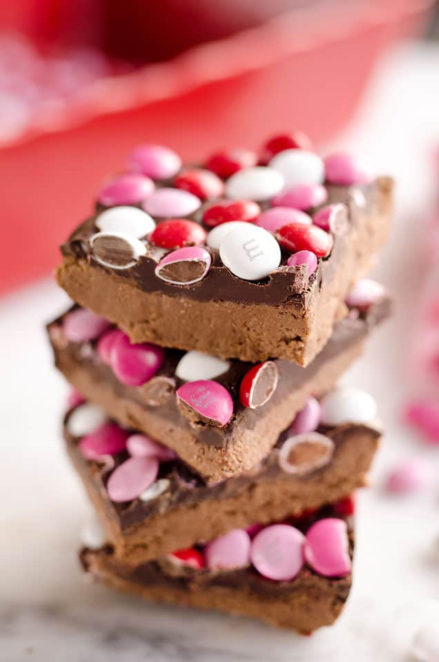 Triple Chocolate Peanut Butter No Bake Bars are a delicious dessert recipe ready in only 15 minutes. This sweet treat is perfect for Valentine's day or any time a peanut butter and chocolate craving strikes!