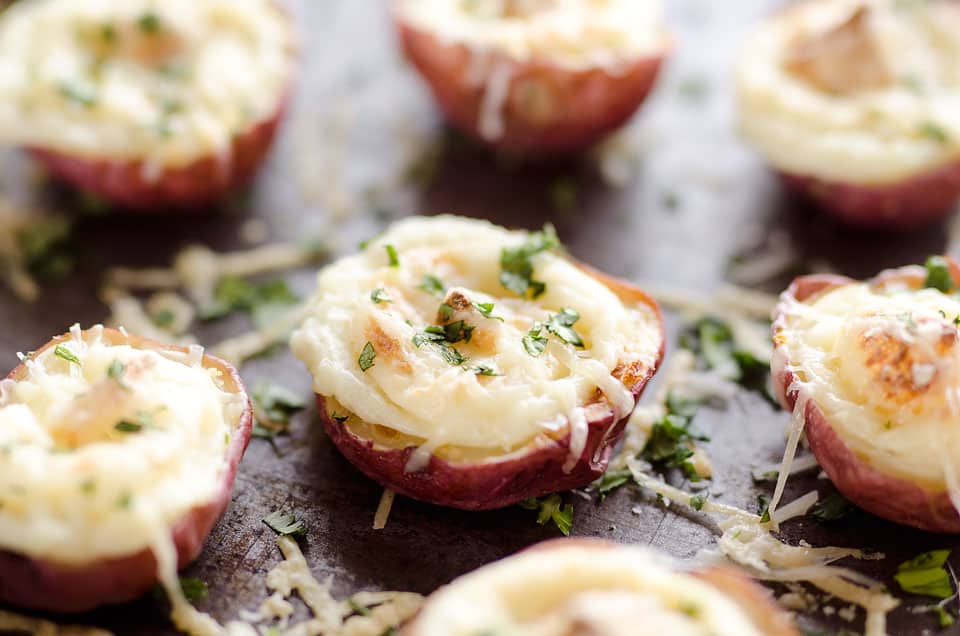 Twice Baked Ranch Potato Poppers are a crowd-pleaser with light and fluffy mashed potatoes mixed with Hidden Valley Ranch seasoning and light sour cream in a potato skin topped with shredded Parmesan for the perfect bite-sized appetizer!