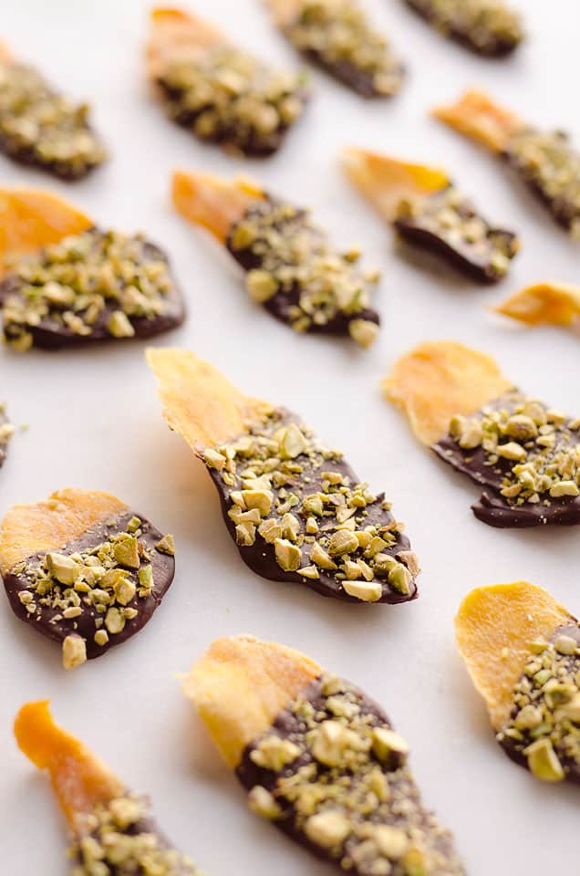 Chocolate & Pistachio Covered Mangoes are an easy and healthy treat to satisfy your sweet tooth! With only 3 simple ingredients, this delicious snack comes together in no time and is perfect for on the go. 