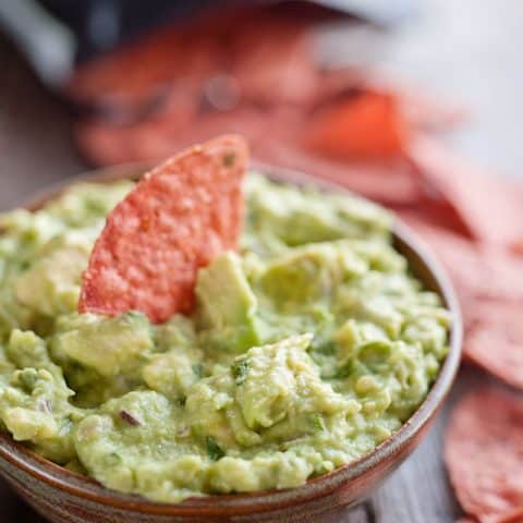 This Easy Guacamole Recipe comes together in minutes and is the perfect dip with salty chips or healthy accompaniment for chicken, shrimp or pork!