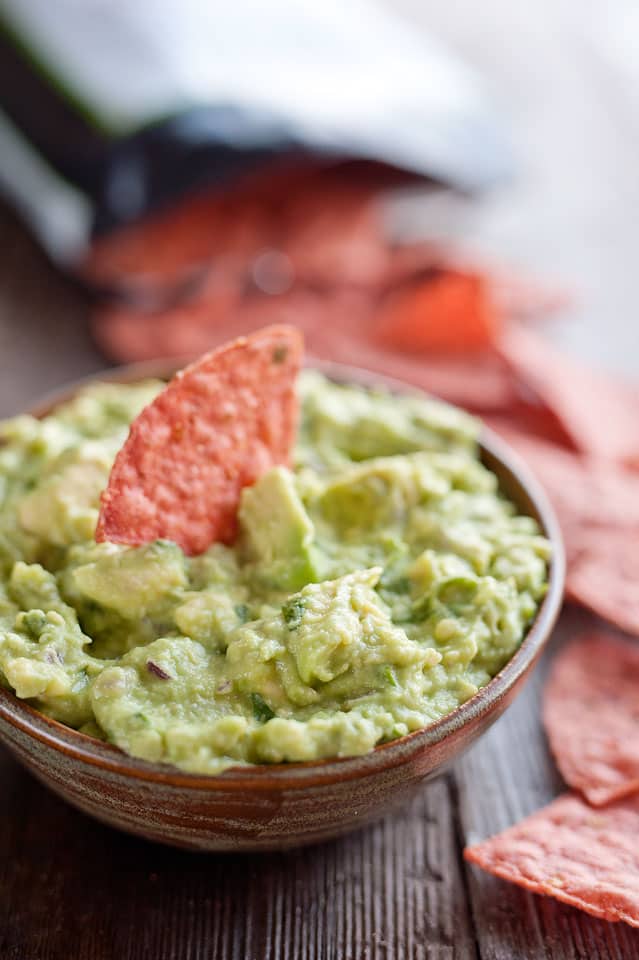 This Easy Guacamole Recipe comes together in minutes and is the perfect dip with salty chips or healthy accompaniment for chicken, shrimp or pork!