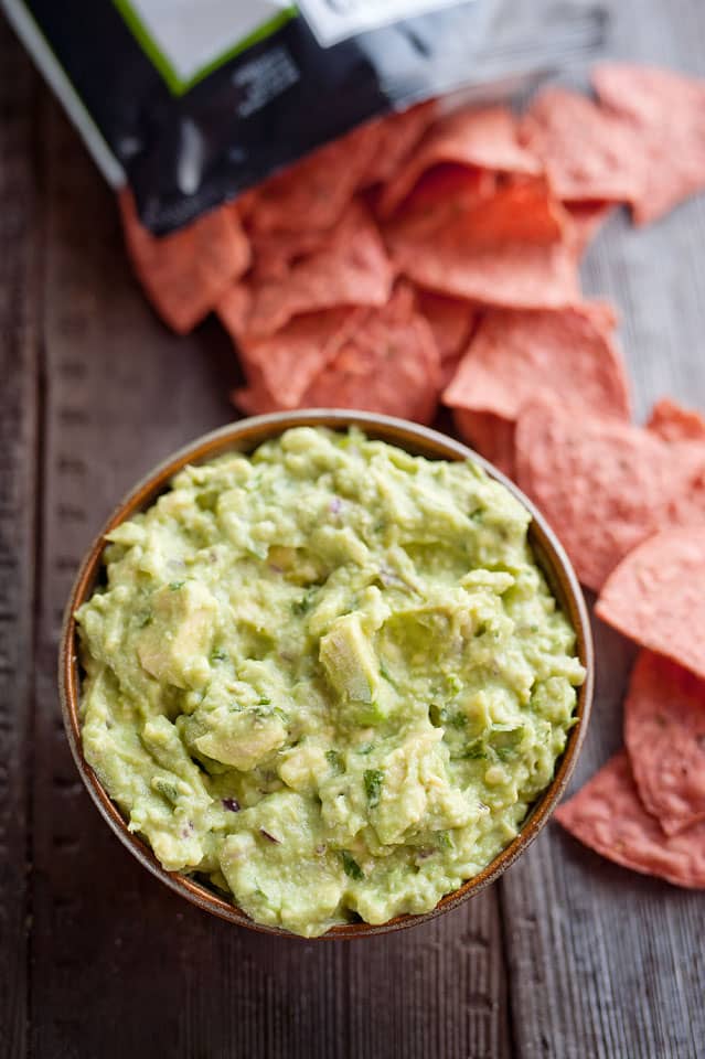 This Easy Guacamole Recipe comes together in minutes and is the perfect dip with salty chips or healthy accompaniment for chicken, shrimp or pork!