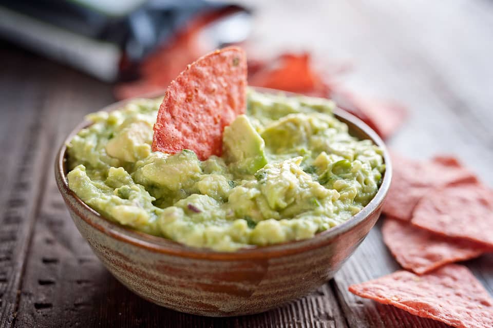 This Easy Guacamole Recipe comes together in minutes and is the perfect dip with salty chips or healthy accompaniment for chicken, shrimp or pork!