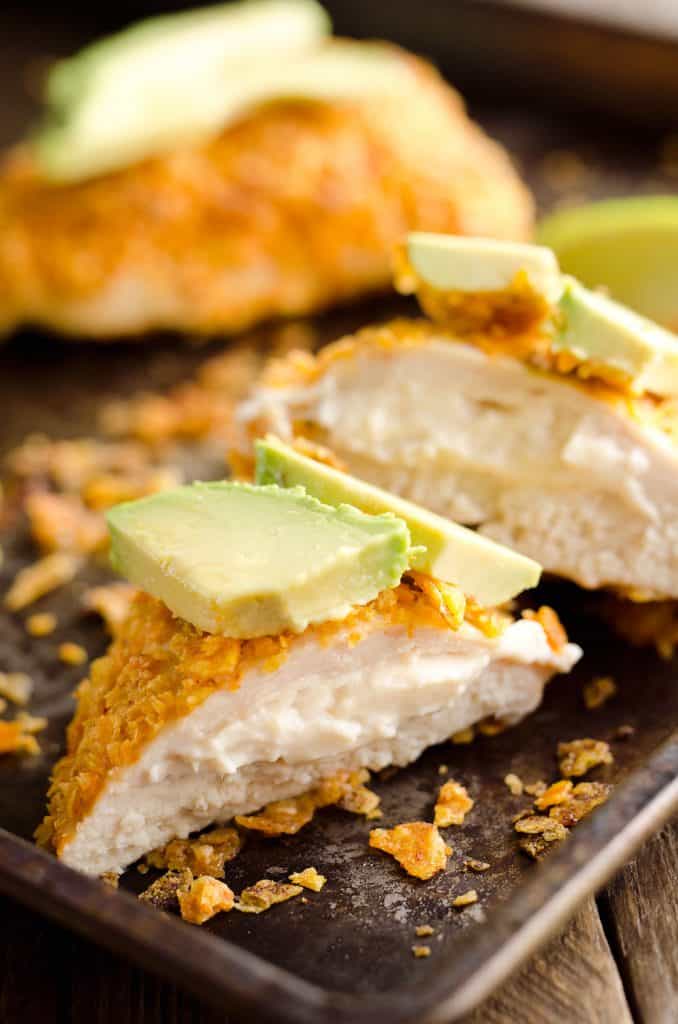 {3 Ingredient} Cheesy Dorito Chicken is a light and delicious dinner with tender chicken breasts stuffed with a creamy queso fresco cheese and coated in crunchy Dorito chips.