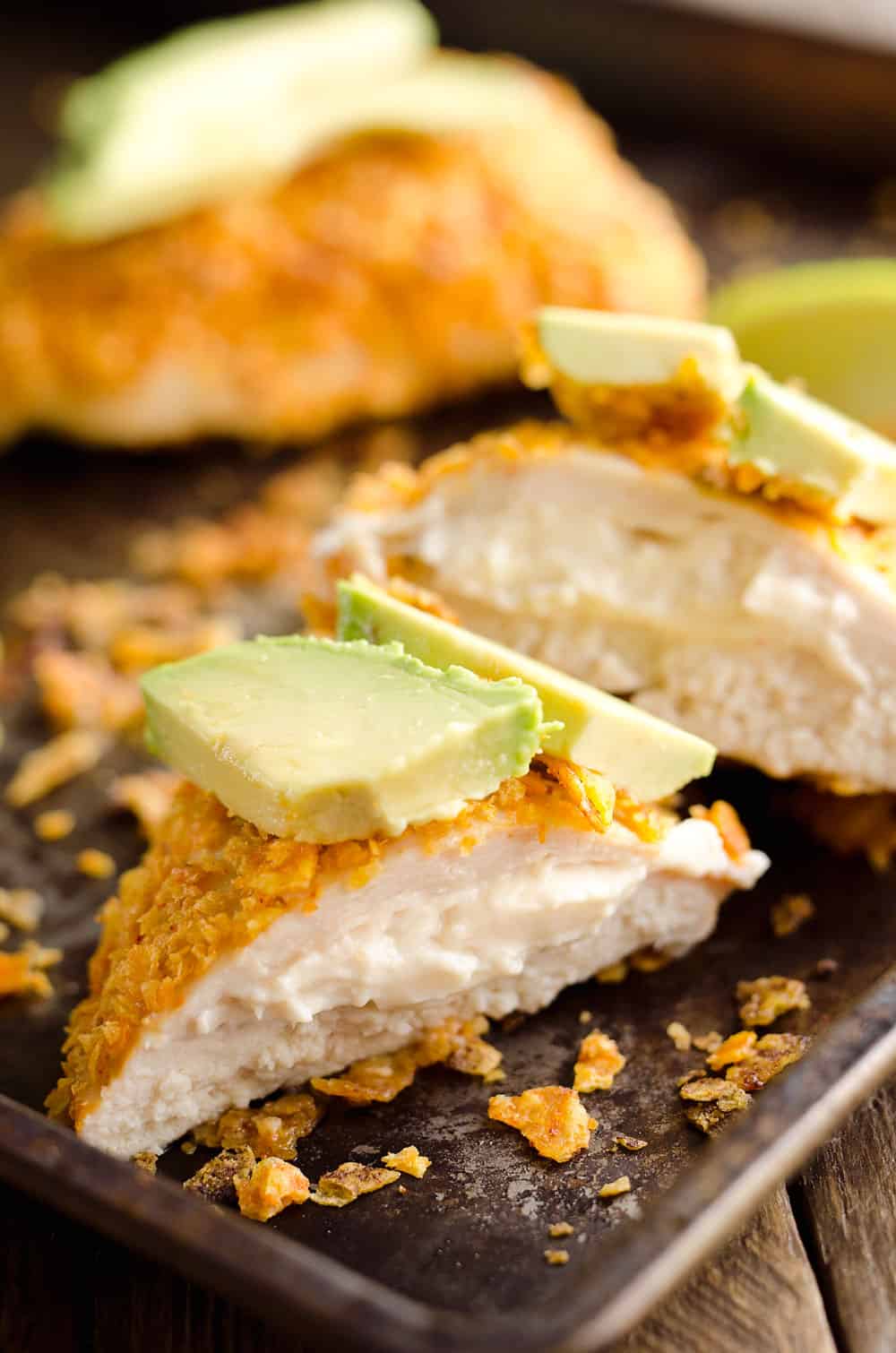 {3 Ingredient} Cheesy Dorito Chicken is a light and delicious dinner with tender chicken breasts stuffed with a creamy queso fresco cheese and coated in crunchy Dorito chips. 