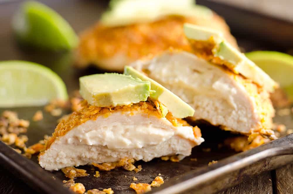 {3 Ingredient} Cheesy Dorito Chicken is a light and delicious dinner with tender chicken breasts stuffed with a creamy queso fresco cheese and coated in crunchy Dorito chips. 