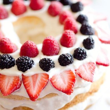 Light Berry Angel Food Cake is an easy and delicious 15 minute dessert. Angel food cake is layered with luscious white chocolate Cool Whip and topped with fresh berries for a guilt-free treat!