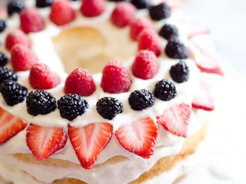 Light Berry Angel Food Cake is an easy and delicious 15 minute dessert. Angel food cake is layered with luscious white chocolate Cool Whip and topped with fresh berries for a guilt-free treat!