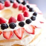 Light Berry Angel Food Cake is an easy and delicious 15 minute dessert. Angel food cake is layered with luscious white chocolate Cool Whip and topped with fresh berries for a guilt-free treat!