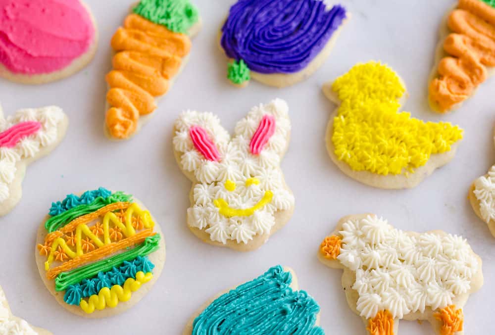 These Frosted Sugar Cookies are the best you will ever try! These adorable spring cut-outs have a cake-like softness topped with a rich buttercream frosting and the perfect balance of sweetness.