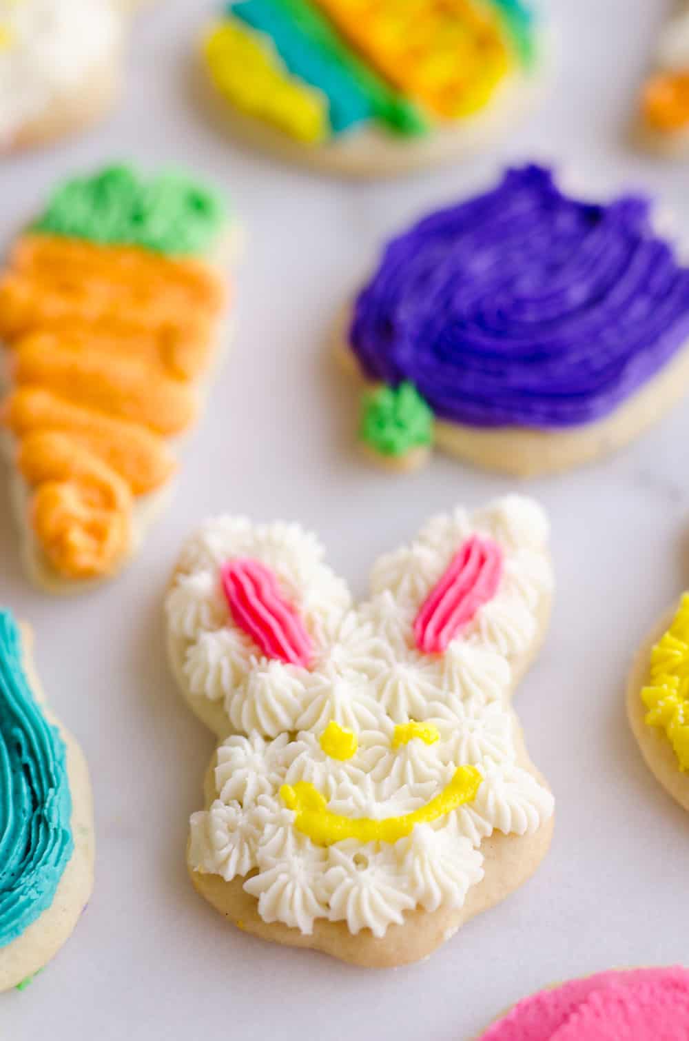 These Frosted Sugar Cookies are the best you will ever try! These adorable spring cut-outs have a cake-like softness topped with a rich buttercream frosting and the perfect balance of sweetness.
