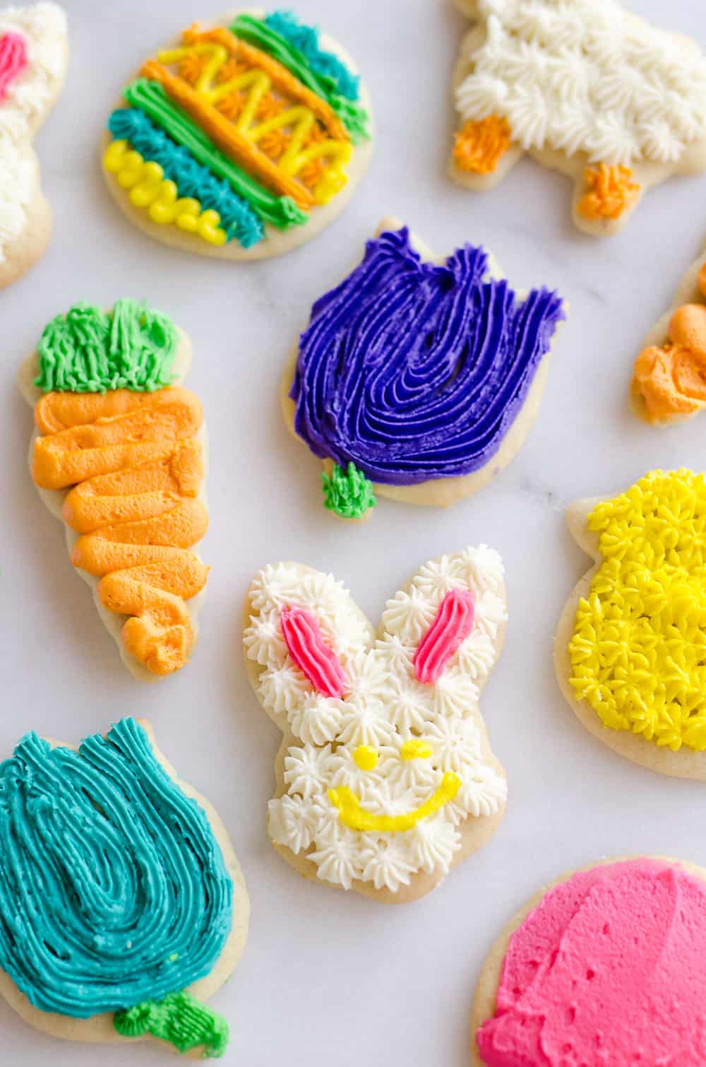 These Frosted Sugar Cookies are the best you will ever try! These adorable spring cut-outs have a cake-like softness topped with a rich buttercream frosting and the perfect balance of sweetness.