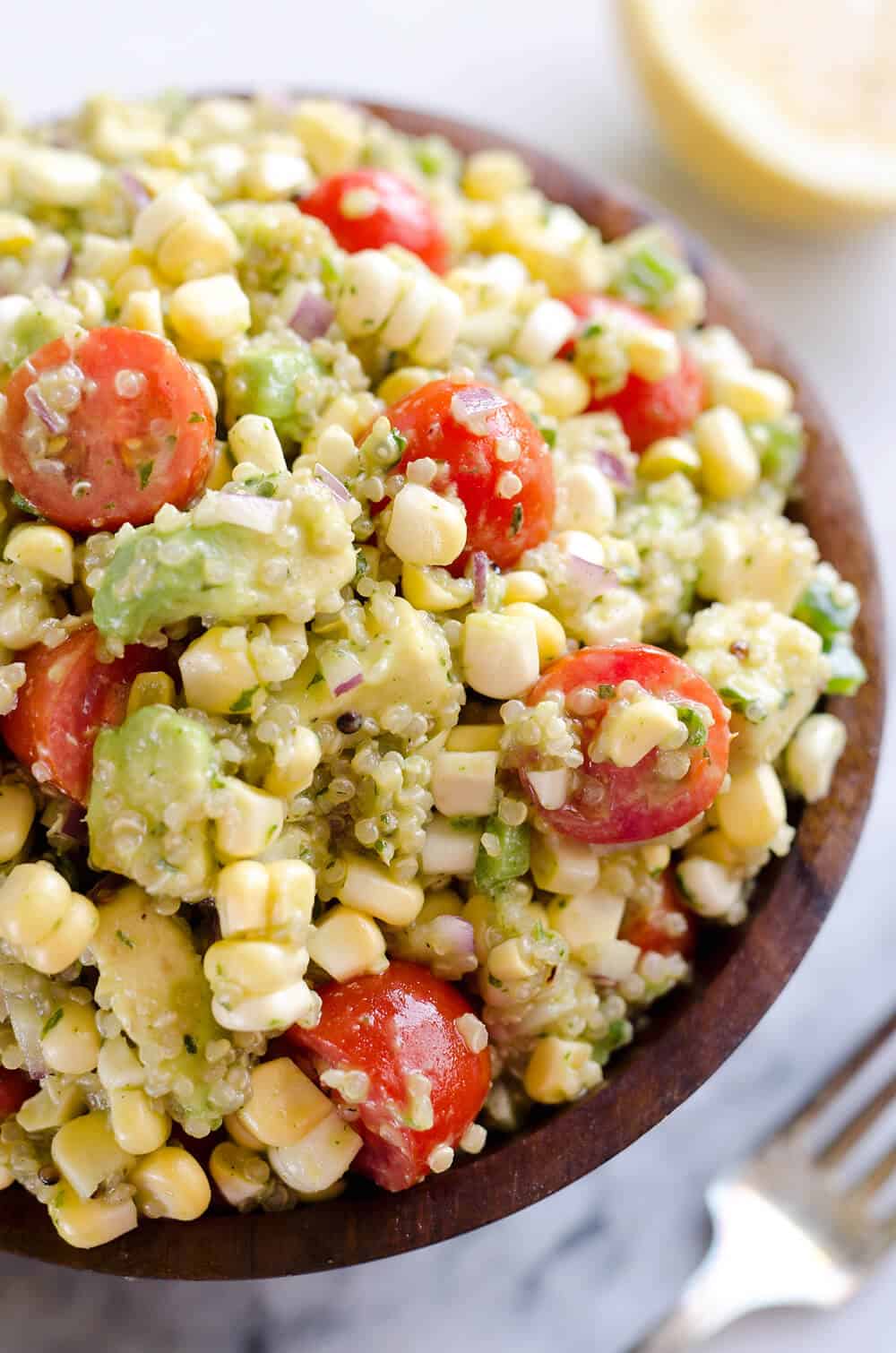 Cilantro Quinoa Corn Salad is a light and refreshing salad perfect for an easy packed lunch or a side salad for a cookout. This salad is a healthy combination of quinoa, corn, avocado and a light Cilantro Lemon dressing with a kick of spice from fresh jalapeños for a dish you will love! 