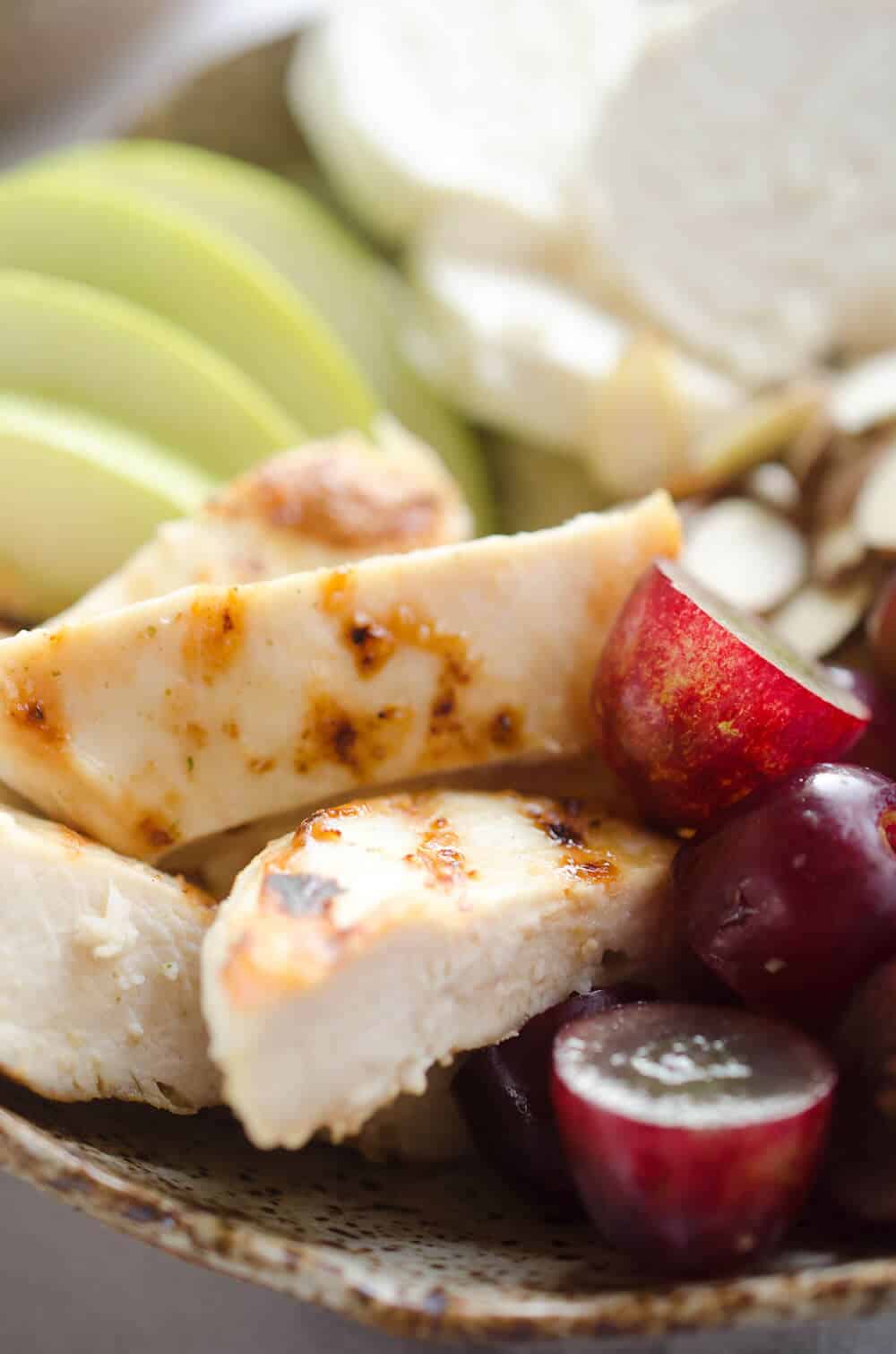 Fruit & Goat Cheese Chicken Bowls are an easy 5 ingredient recipe for a healthy dinner loaded with sweet and savory flavors. Tender chicken breasts are paired with juicy grapes, apples, almonds and creamy honey goat cheese for an amazingly simple and protein packed meal ready in only 15 minutes!
