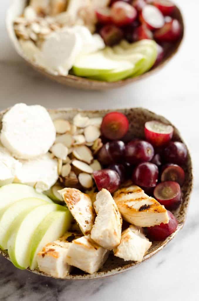 Fruit & Goat Cheese Chicken Bowls are a fresh and easy recipe for a healthy dinner loaded with sweet and savory flavors. Tender chicken breasts are paired with juicy grapes, apples, almonds and creamy honey goat cheese for an amazingly simple meal!