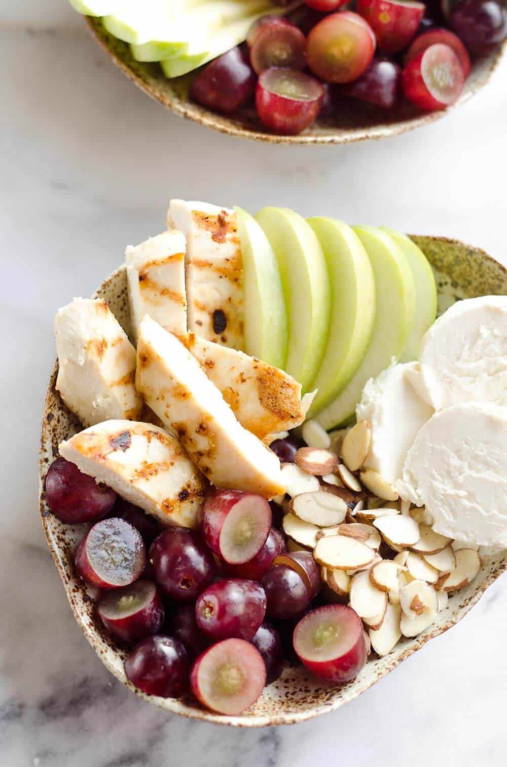 Fruit & Goat Cheese Chicken Bowls are a fresh and easy recipe for a healthy dinner loaded with sweet and savory flavors. Tender chicken breasts are paired with juicy grapes, apples, almonds and creamy honey goat cheese for an amazingly simple meal!