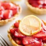 Mini Strawberry Lemon Pies are the perfect dessert recipe to serve your party guests for an individual sweet they will love! A flaky pie crust is topped with a lemon cream cheese layer, fresh strawberries and a sweet strawberry lemon sauce for tons of great flavor and texture!