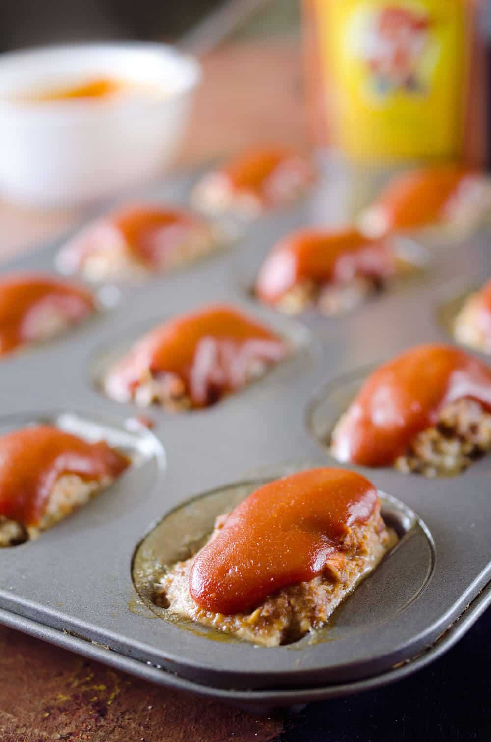 Skinny Mini Zesty Meatloaves are a healthy and wholesome dinner full of hidden vegetables. A tender recipe for meatloaf is topped with an easy and zesty mixture of ketchup and Heinz 57 for a unique take on a classic.