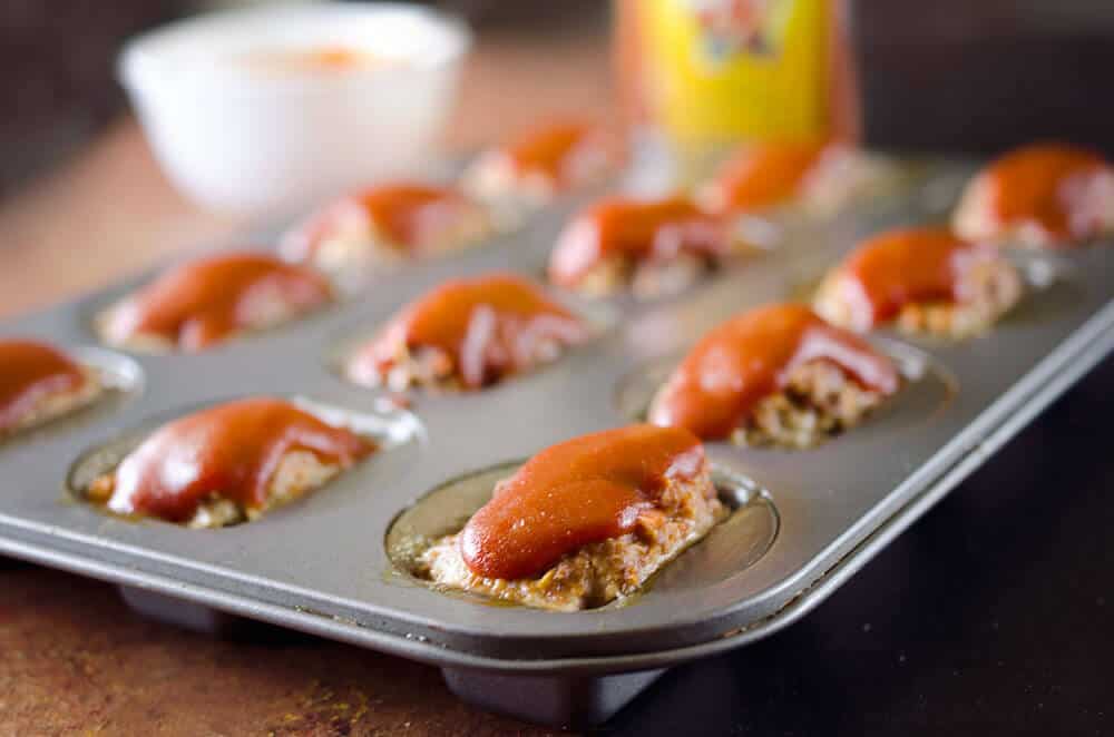 Skinny Mini Zesty Meatloaves are a healthy and wholesome dinner full of hidden vegetables. A tender recipe for meatloaf is topped with an easy and zesty mixture of ketchup and Heinz 57 for a unique take on a classic. 