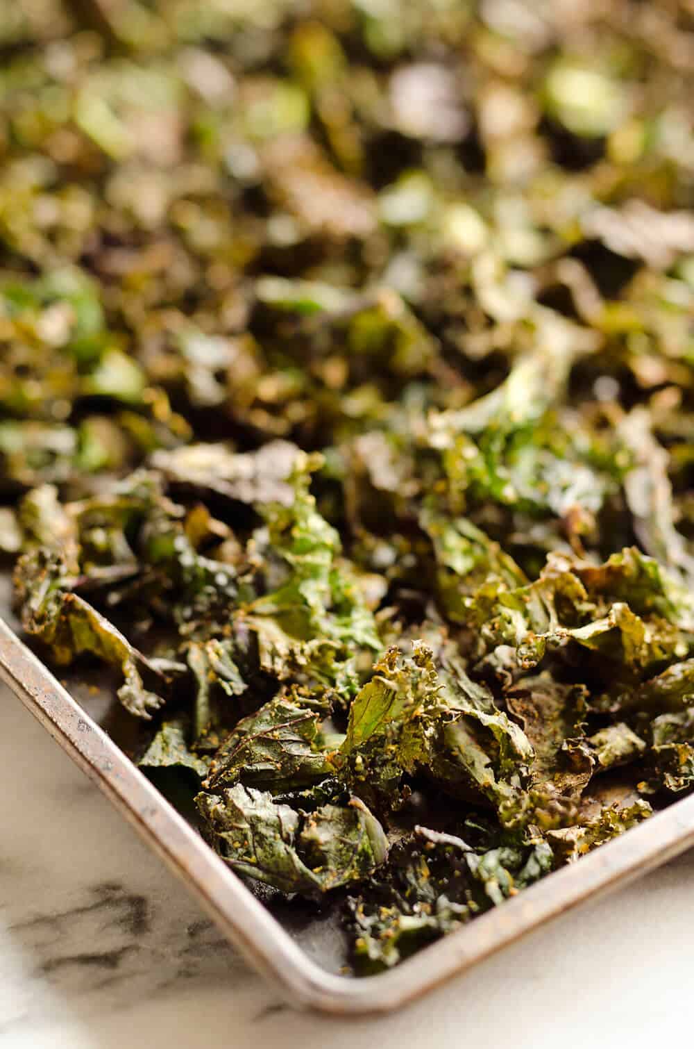 Spicy Kale Chips are beautifully crisp and loaded with bold chipotle flavor for a healthy 5 ingredient snack. They are perfect for the munchies or paired with your favorite sandwich on the side!