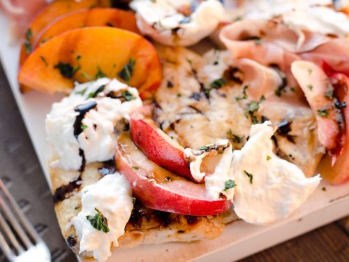 Balsamic Chicken with Peaches & Prosciutto is a deliciously simple and healthy dinner made on the grill in just 10 minutes! Grilled chicken is topped with fresh peaches and burrata cheese and finished off with a balsamic reduction and basil for a combination of flavors you will love.